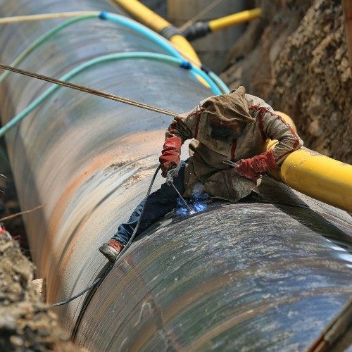Man welds a pipeline.